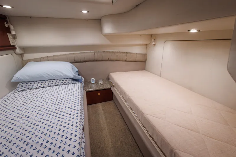 Interior cabin of 1997 Maxum 4600 SCB yacht with twin beds and modern lighting.