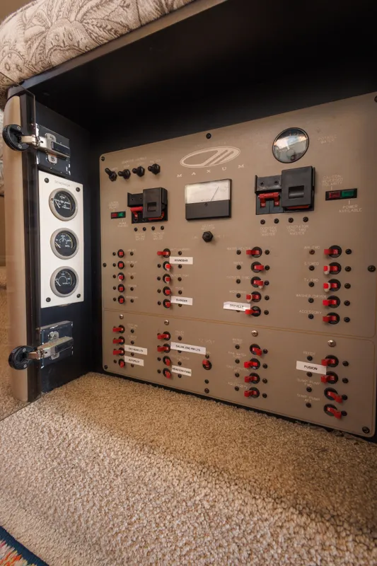 Electrical control panel inside a 1997 Maxum 4600 SCB yacht, featuring switches and gauges.