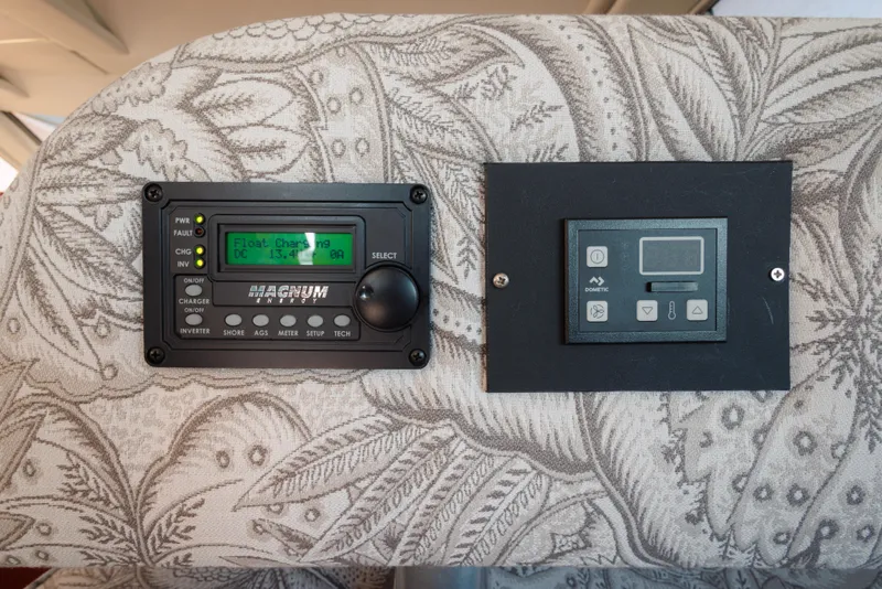 Control panels on a 1997 Maxum 4600 SCB boat, featuring Magnum Energy and Dometic displays.
