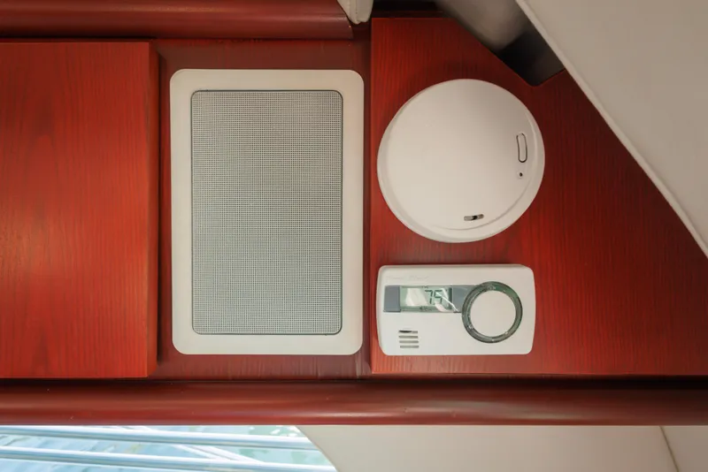 Interior of 1997 Maxum 4600 SCB yacht with speaker, smoke detector, and thermostat.