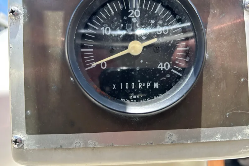 Close-up of a tachometer on a 1984 Irwin 34 sailboat, displaying RPM measurements.