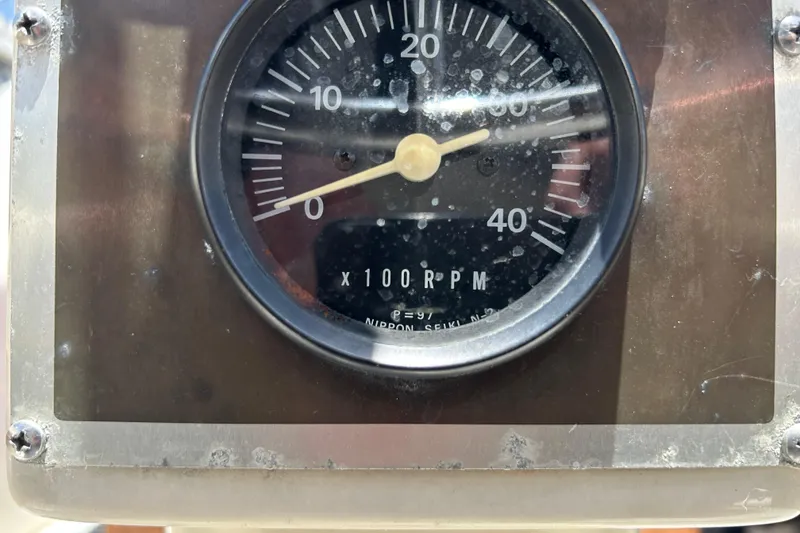 Close-up of a 1984 Irwin 34 RPM gauge, showing readings up to 40 x 100 RPM.