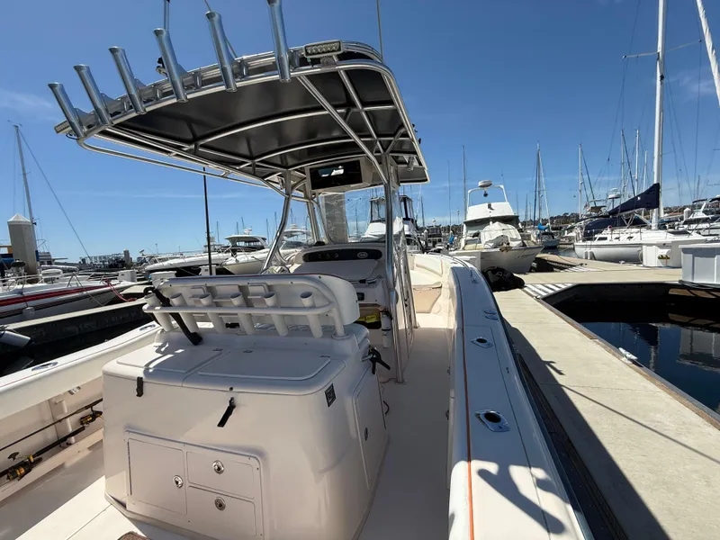 2005 Grady-White Bimini 306 boat docked at marina under clear blue sky.