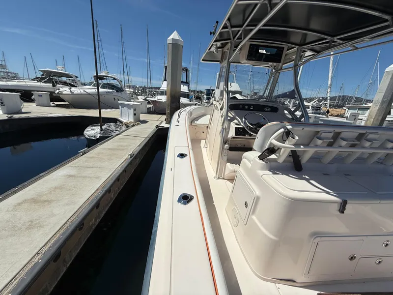 2005 Grady-White Bimini 306 boat docked at marina under clear blue sky.
