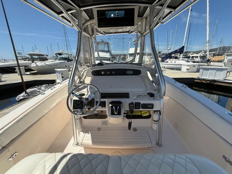 2005 Grady-White Bimini 306 boat interior with steering wheel, docked at marina.