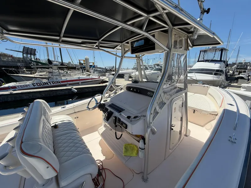 2005 Grady-White Bimini 306 boat interior at marina, featuring helm and seating.