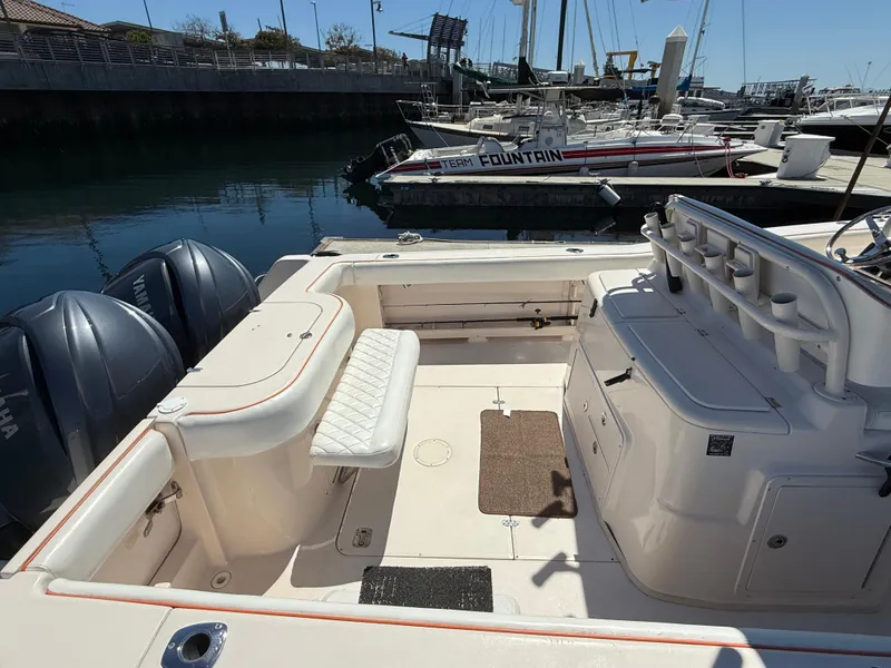 2005 Grady-White Bimini 306 boat interior at marina, featuring seating and storage.