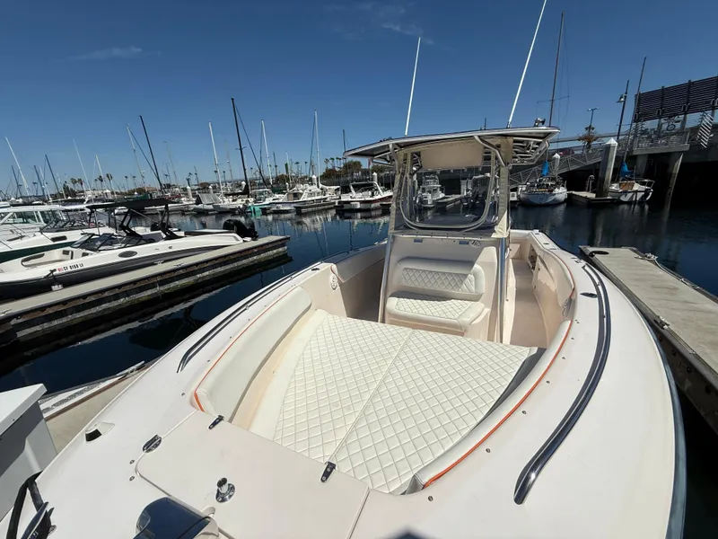 2005 Grady-White Bimini 306 boat docked in marina, featuring spacious seating and sleek design.