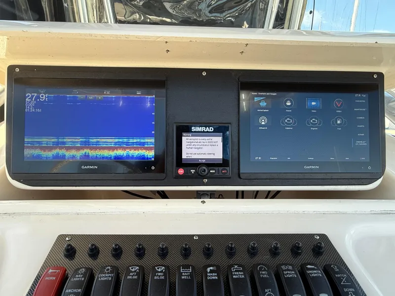 2005 Grady-White Bimini 306 dashboard with Garmin and Simrad displays.