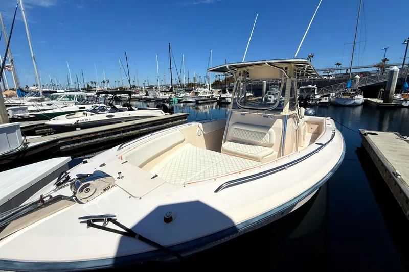 2005 Grady-White Bimini 306 boat docked in a marina under clear blue skies.