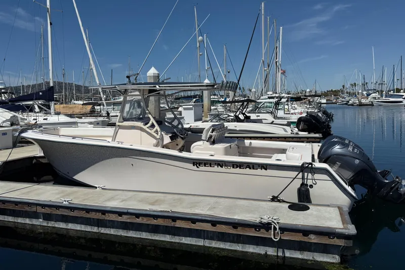 2005 Grady-White Bimini 306 boat docked in a marina with clear blue skies.