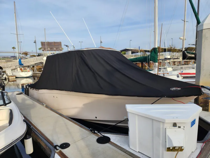 2005 Grady-White Bimini 306 boat covered at marina dock.