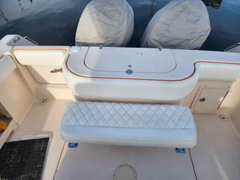2005 Grady-White Bimini 306 boat interior with cushioned seating and covered engines.