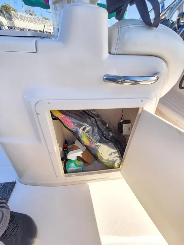 Storage compartment on a 2005 Grady-White Bimini 306 boat, containing various items.