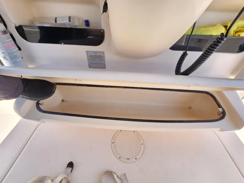 Open storage compartment on 2005 Grady-White Bimini 306 boat deck.