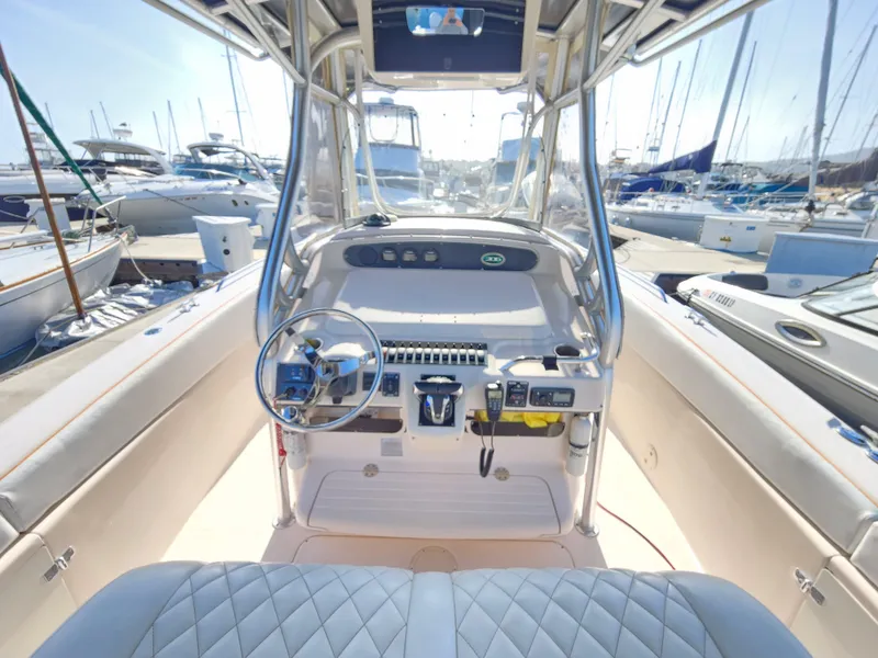 2005 Grady-White Bimini 306 boat cockpit with steering wheel and controls, docked at marina.