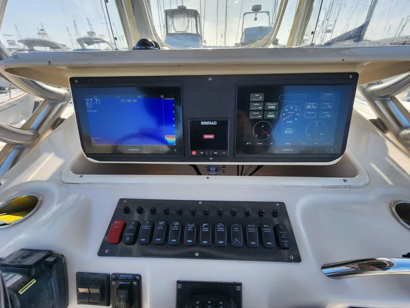 Control panel of 2005 Grady-White Bimini 306 boat with navigation screens.