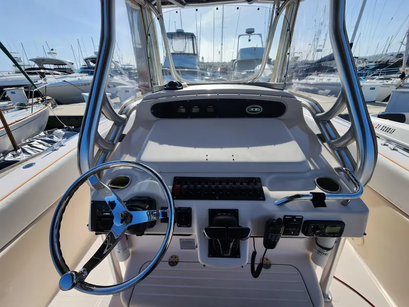 2005 Grady-White Bimini 306 boat helm with steering wheel and controls at marina.