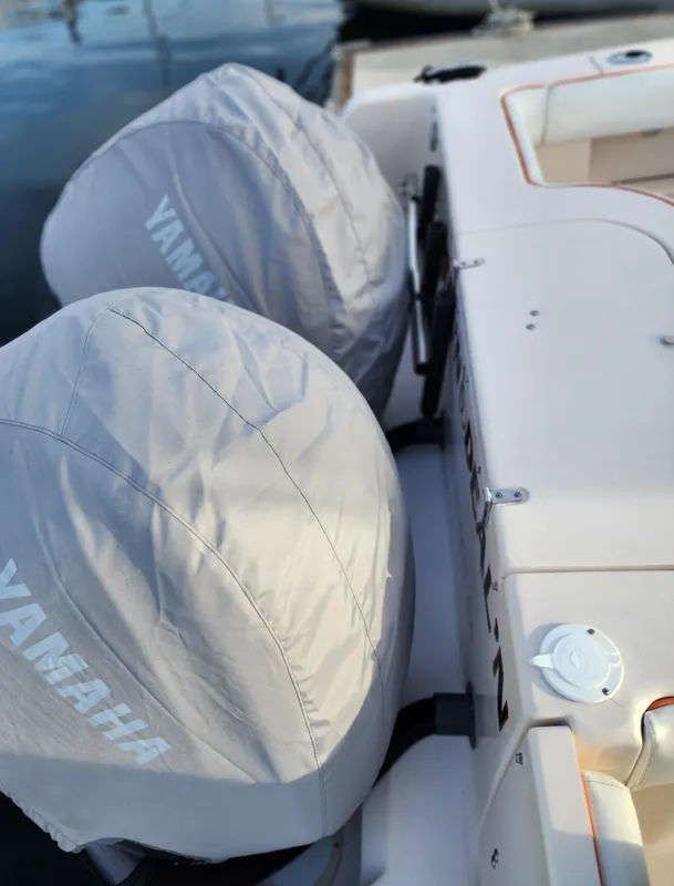 2005 Grady-White Bimini 306 with Yamaha engines, docked, featuring covered outboard motors.