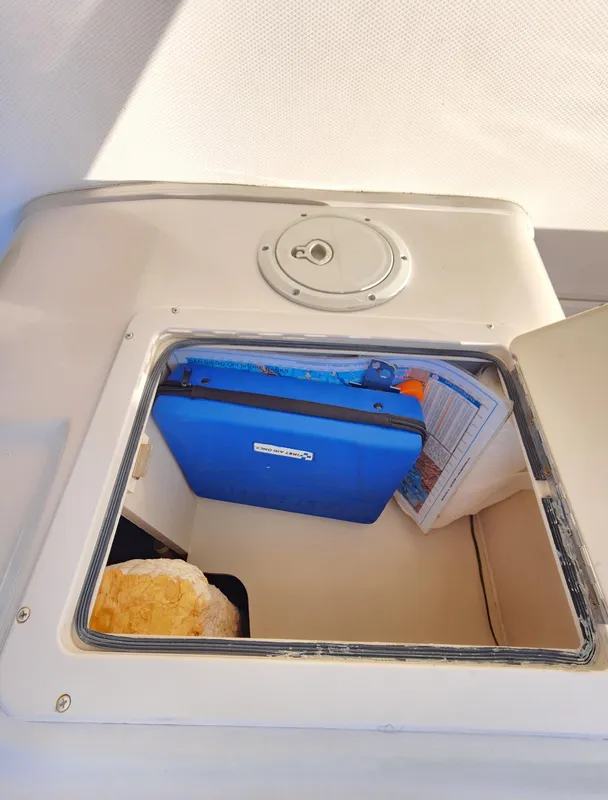Storage compartment on a 2005 Grady-White Bimini 306 boat, containing various items.