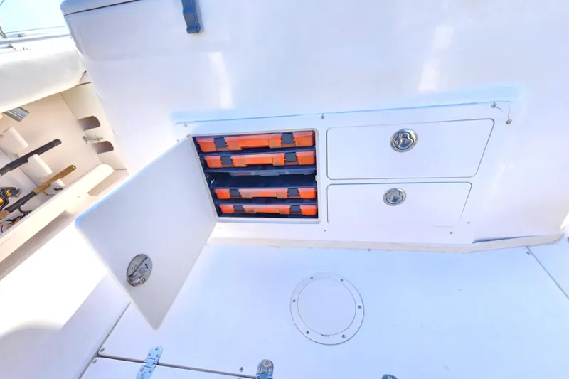 2005 Grady-White Bimini 306 boat storage compartments with tackle boxes and drawers.