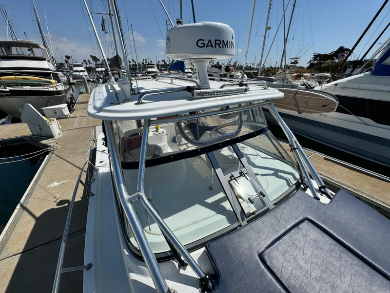 2008 Boston Whaler 285 Conquest boat docked, featuring Garmin radar, in a marina setting.