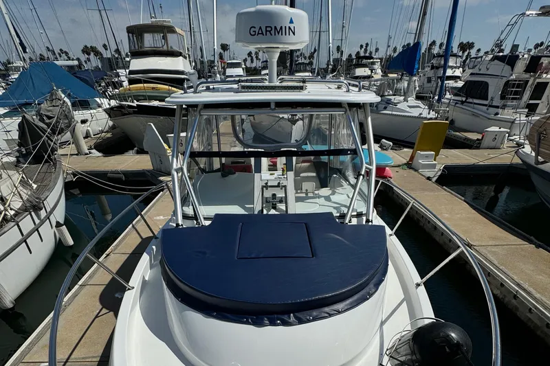 2008 Boston Whaler 285 Conquest docked, featuring Garmin equipment, surrounded by other boats.