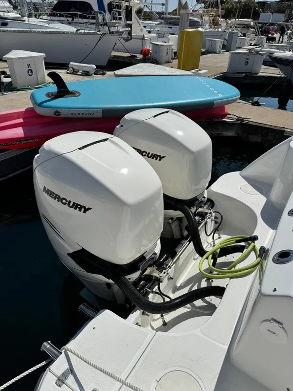 Twin Mercury outboard engines on a 2008 Boston Whaler 285 Conquest at a marina.