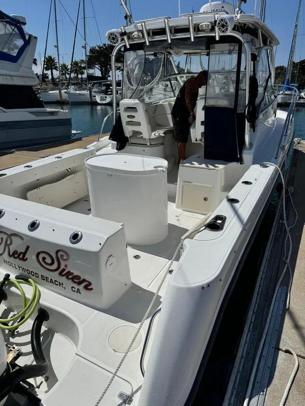 2008 Boston Whaler 285 Conquest boat docked at marina, rear view.