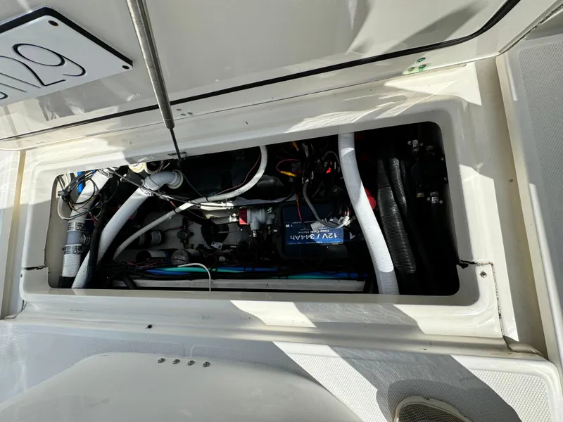 Engine compartment of a 2008 Boston Whaler 285 Conquest boat, showing wiring and components.
