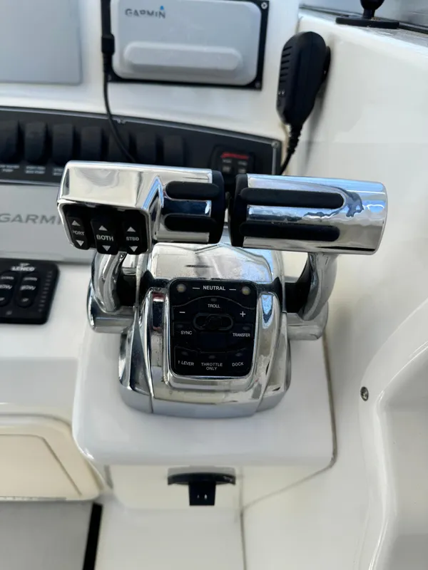 Throttle controls on a 2008 Boston Whaler 285 Conquest boat dashboard.