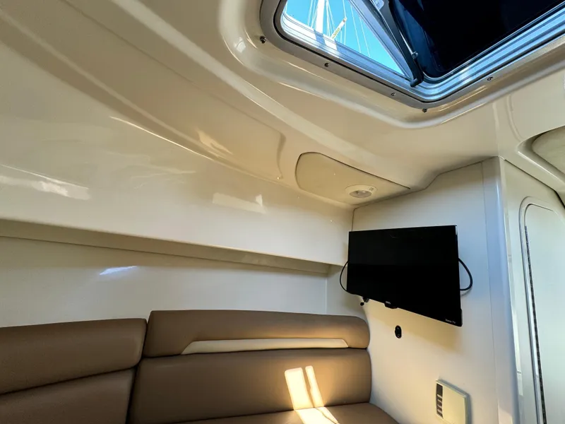 Interior of 2008 Boston Whaler 285 Conquest with seating and mounted TV.