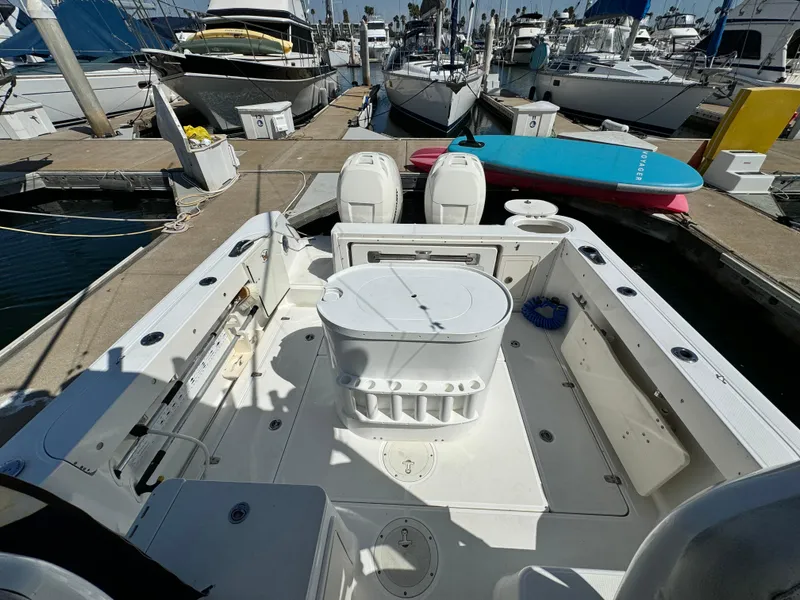 2008 Boston Whaler 285 Conquest boat docked at marina, featuring spacious deck and twin engines.