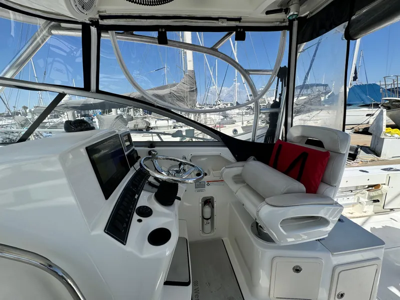 2008 Boston Whaler 285 Conquest helm with steering wheel and navigation equipment.