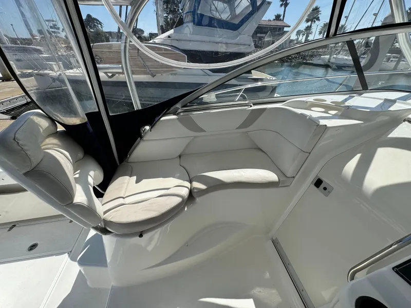 2008 Boston Whaler 285 Conquest interior seating area with marina view.