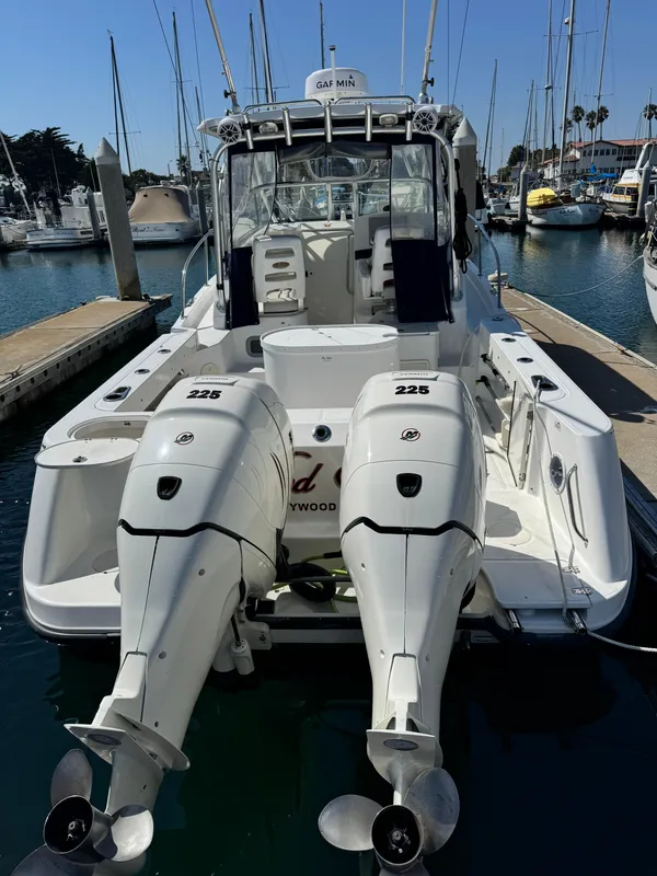 2008 Boston Whaler 285 Conquest boat with twin engines docked at marina.