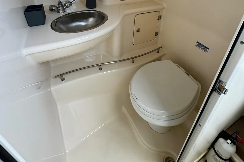 2008 Boston Whaler 285 Conquest boat bathroom with sink and toilet.