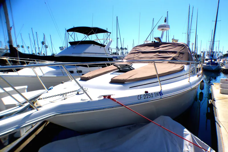 2002 Sea Ray 340 Amberjack docked at marina, covered and ready for sailing.