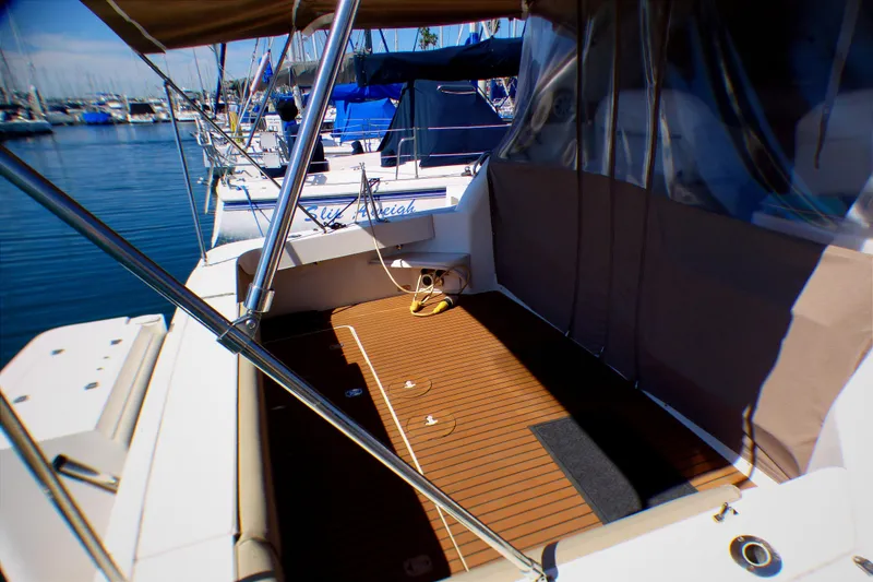 2002 Sea Ray 340 Amberjack boat deck with canopy, docked in marina.