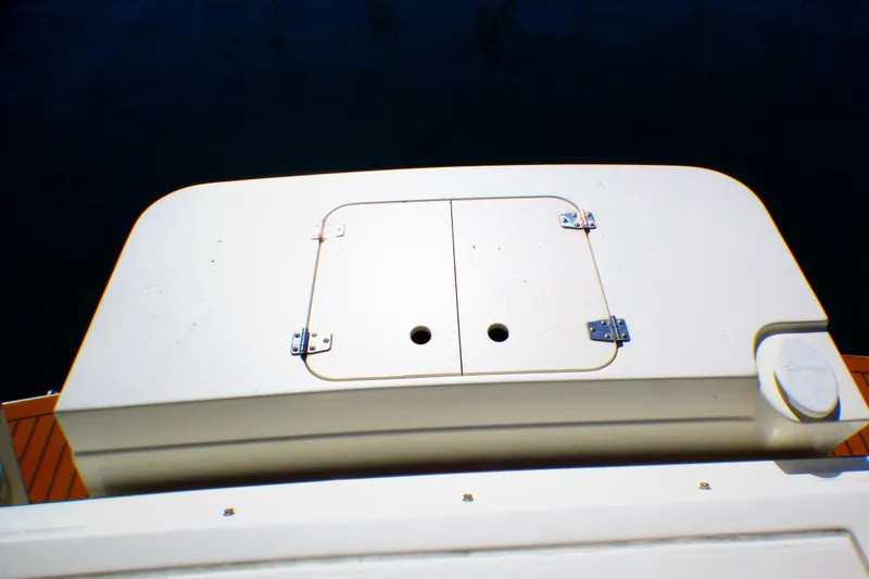 2002 Sea Ray 340 Amberjack boat deck with storage compartment.