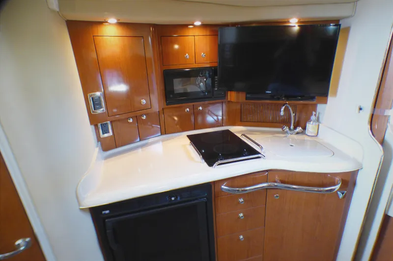 Luxurious 2002 Sea Ray 340 Amberjack yacht kitchen with modern amenities and sleek design.