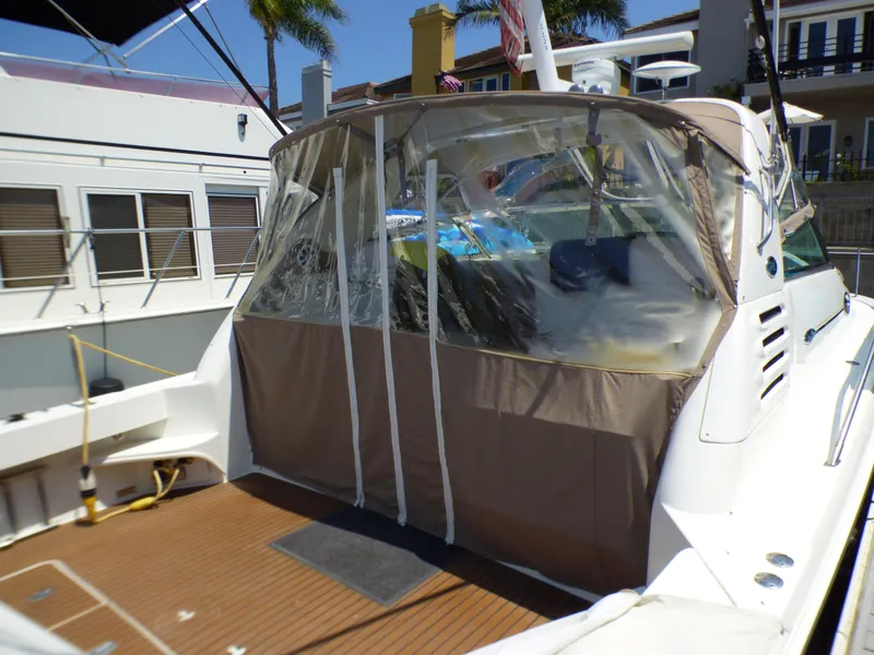 2002 Sea Ray 340 Amberjack with canopy in harbor.