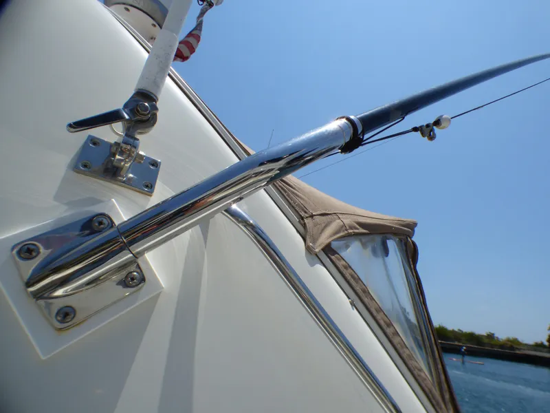 Close-up of a 2002 Sea Ray 340 Amberjack yacht with fishing rod.
