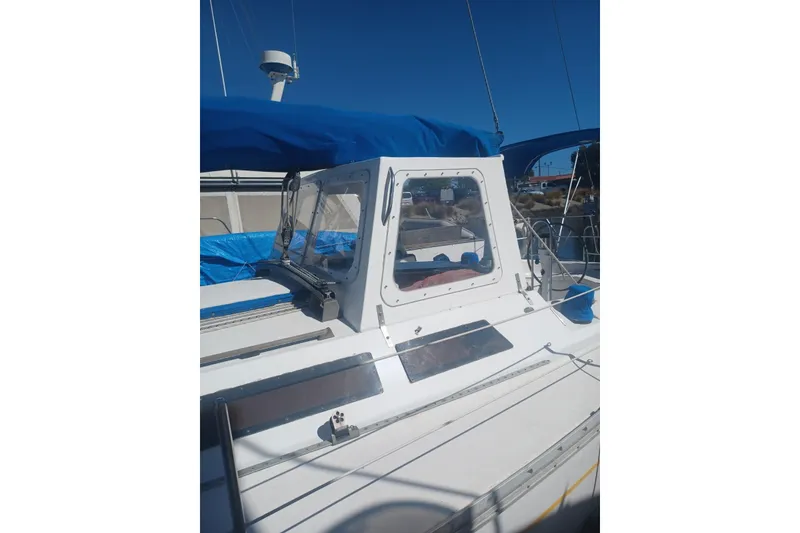 1987 O'Day 40 sailboat with blue canopy and clear cockpit enclosure.