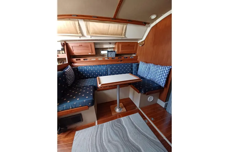 1987 O'Day 40 yacht interior with cozy seating and wooden accents.