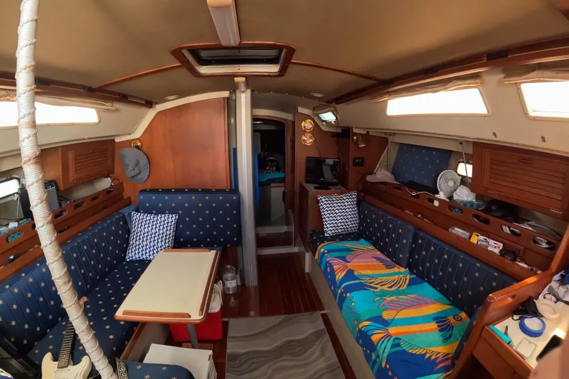 Interior of a 1987 O'Day 40 sailboat with cozy seating and vibrant decor.