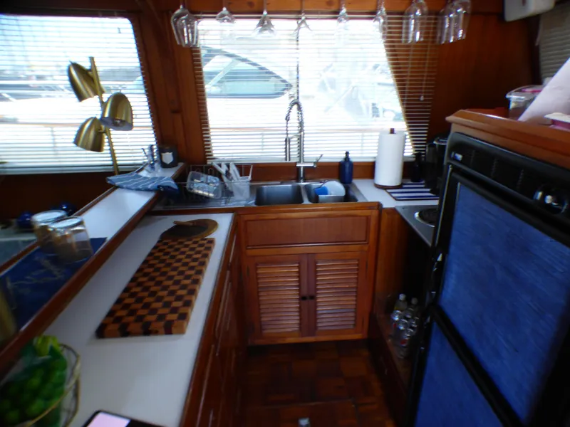 1980 CHB Heritage 42 Trawler kitchen with wooden cabinets and modern appliances.
