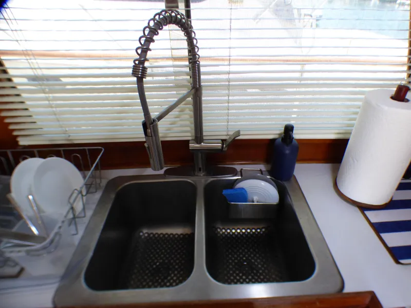 1980 CHB Heritage 42 Trawler kitchen sink with modern faucet and accessories.