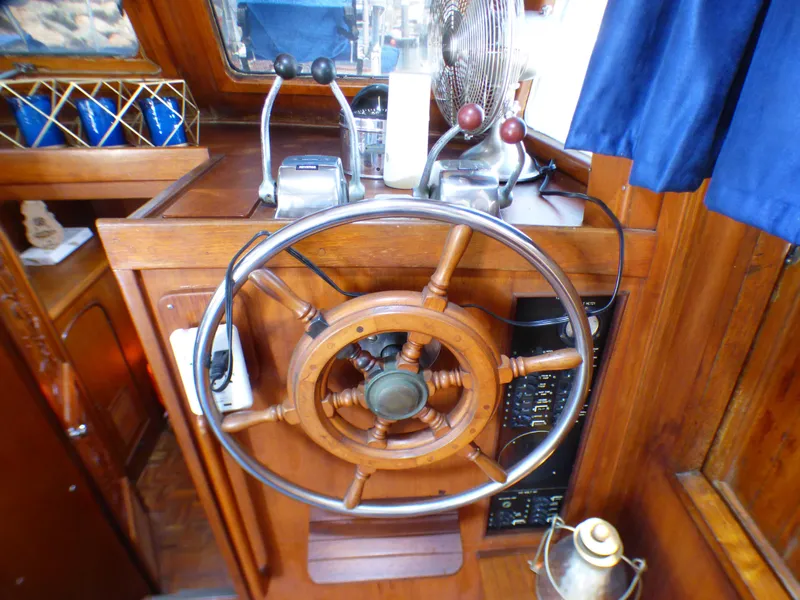 Wooden helm station of 1980 CHB Heritage 42 Trawler with classic wheel and controls.
