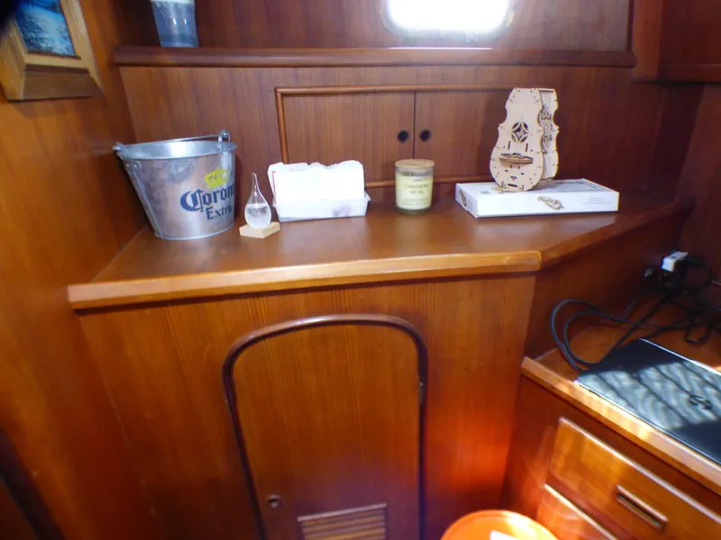 Interior of 1980 CHB Heritage 42 Trawler with wooden cabinetry and decor items.